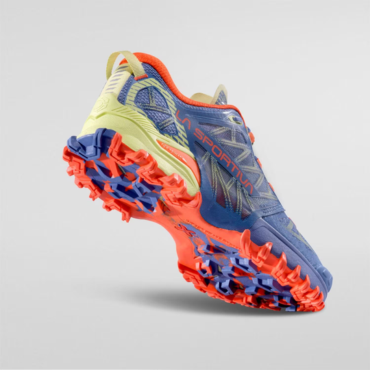 Bushido III Woman trail running shoe with FriXion® Red sole, blue and orange design, showcasing grip and stability features.