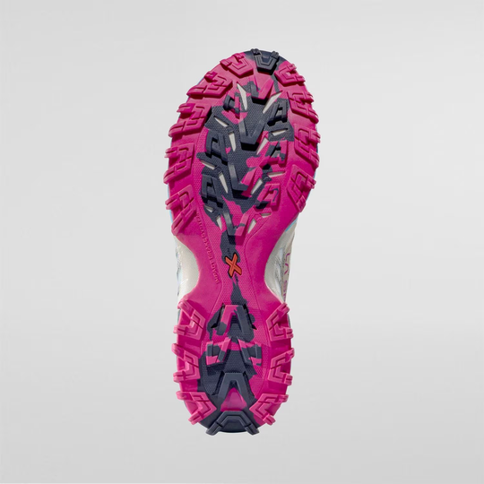 Trail running shoe sole with pink and black aggressive tread pattern, designed for optimal grip; Bushido III Woman.