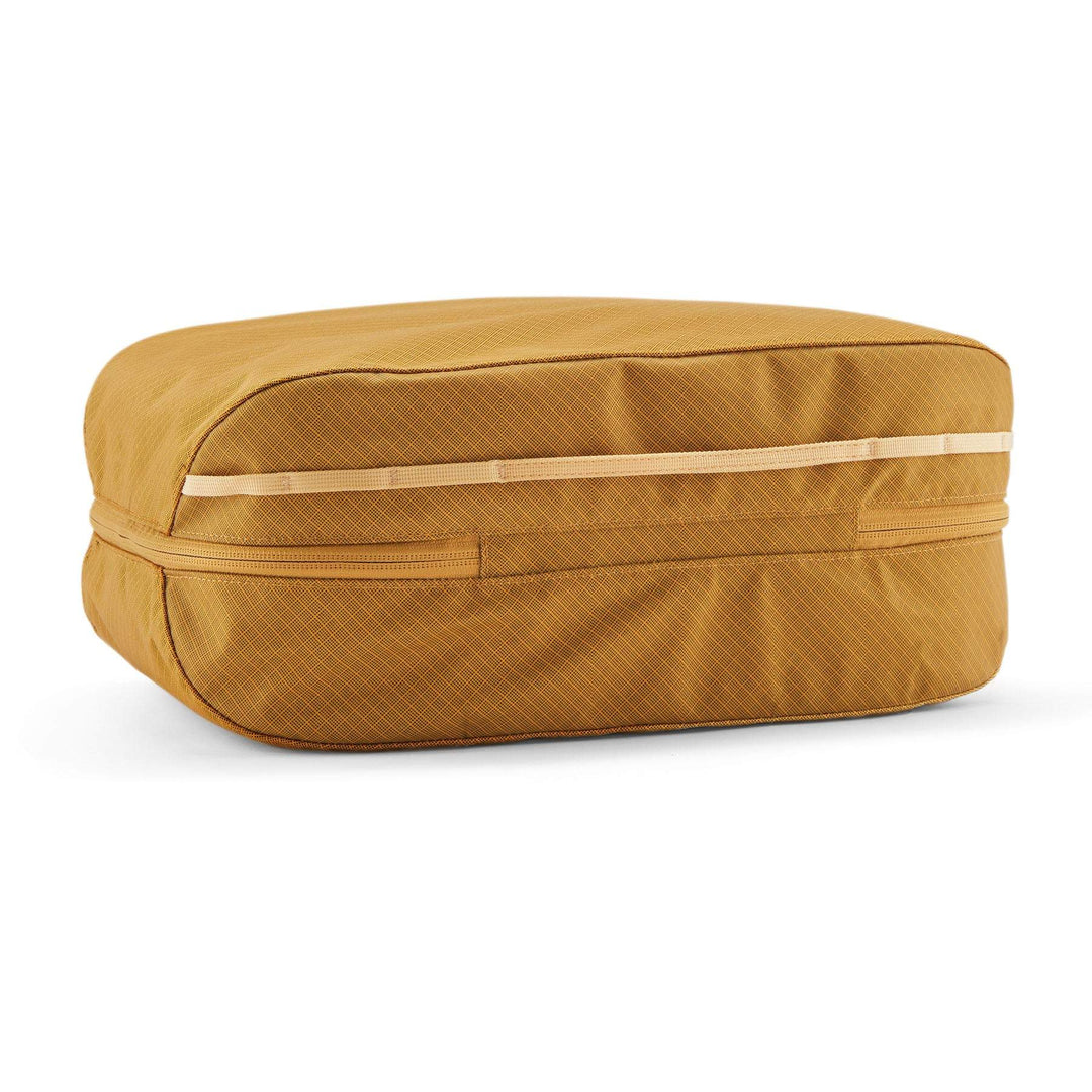 Black Hole Cube 14L in recycled fabric, golden yellow, with zippered compartments and daisy chain loop.