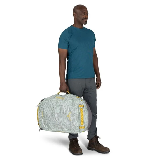 Transporter 65 duffel bag held by person, showcasing durable, weather-resistant material.