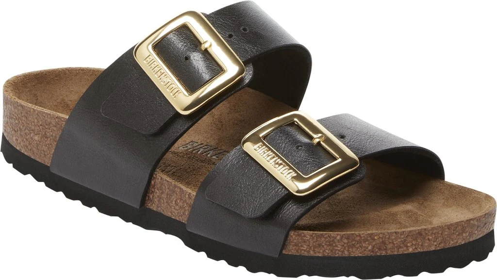 Sidney Birkenstock black sandals with two gold buckle straps and cork-latex footbed.