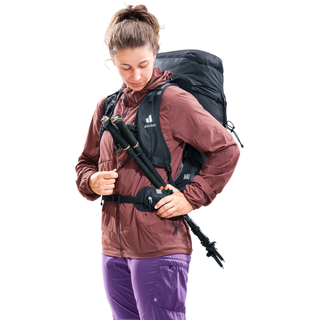 Speed Lite Pro 28 SL backpack in use, featuring lightweight design with front zipper pockets and gear attachments for hiking.