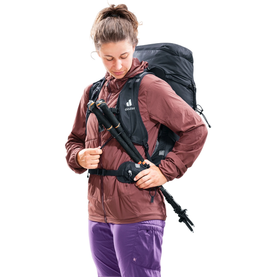 Speed Lite Pro 28 SL backpack in use, featuring lightweight design with front zipper pockets and gear attachments for hiking.
