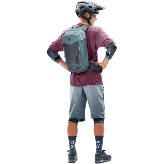 Cyclist wearing Compact 14+3 backpack with helmet, showcasing versatile bike backpack features.