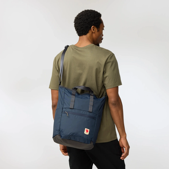 High Coast Totepack worn as backpack, navy color, versatile for everyday use and travel.