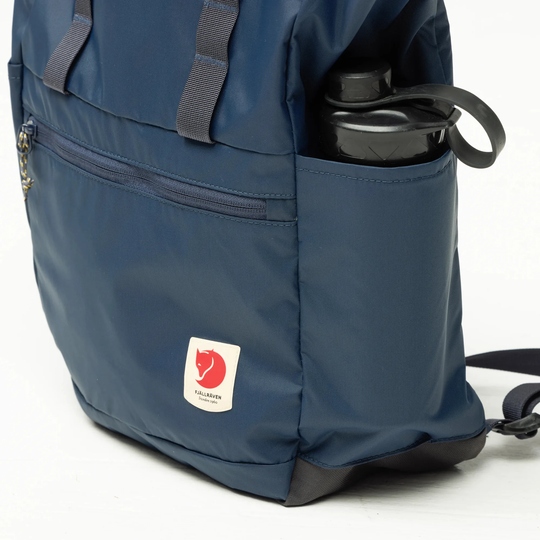 High Coast Totepack, waterproof recycled nylon bag with side pockets and front zipper.