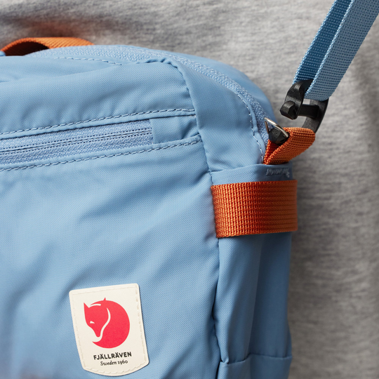 Lightweight blue High Coast Crossbody bag with adjustable strap.