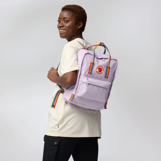 Kånken Rainbow backpack with rainbow straps worn by a person.