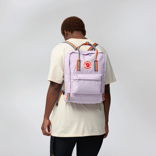 Kånken Rainbow backpack with rainbow straps, worn by a person.