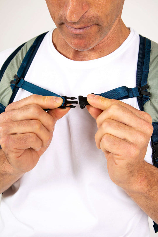 Man adjusting backpack straps in close-up view.