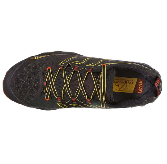 Top view of black Akyra mountain running shoe with yellow laces, designed for endurance trails and ultra marathons.