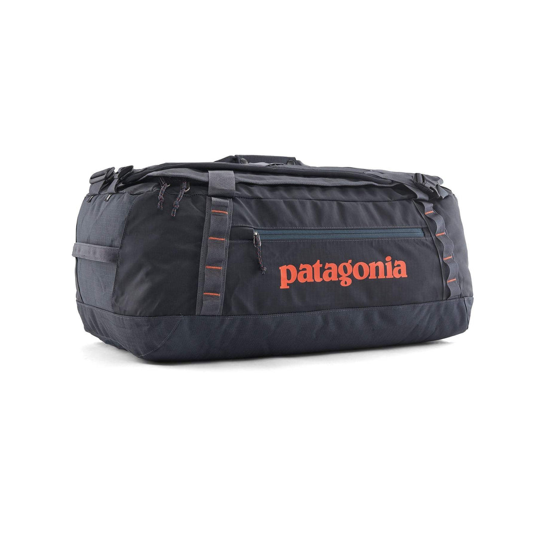 Black Hole Duffel 55L in black with orange logo, versatile travel bag made from 100% recycled, weather-resistant materials.