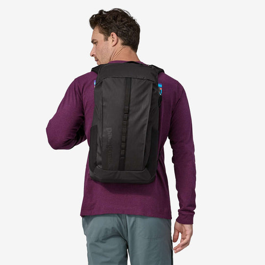 Black Hole Pack 25L backpack in recycled polyester, durable and water-repellent, worn by a person, Fair Trade Certified™.