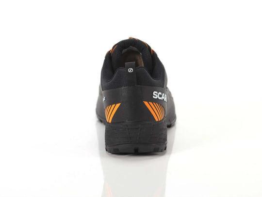 Ribelle Run XT GTX shoe, rear view, black with orange accents, Gore-Tex technology, rugged sole for stability and grip.