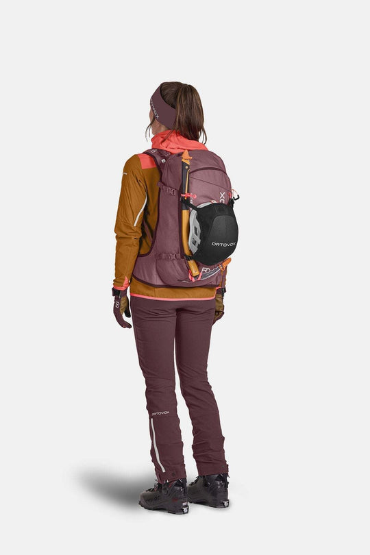 Tour Rider 28 S all-mountain ski backpack worn by a hiker with ski gear.