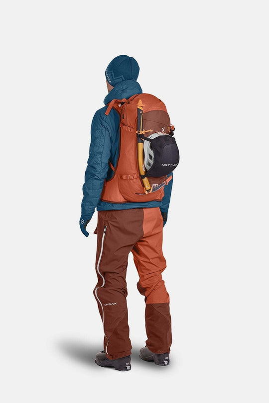 All-mountain ski backpack, Tour Rider 30, shown with technical outdoor gear and helmet attachment.