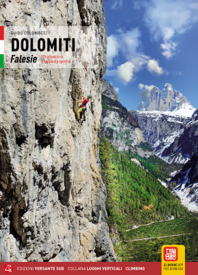 Climber scaling steep Dolomiti Falesie cliff with scenic mountain background